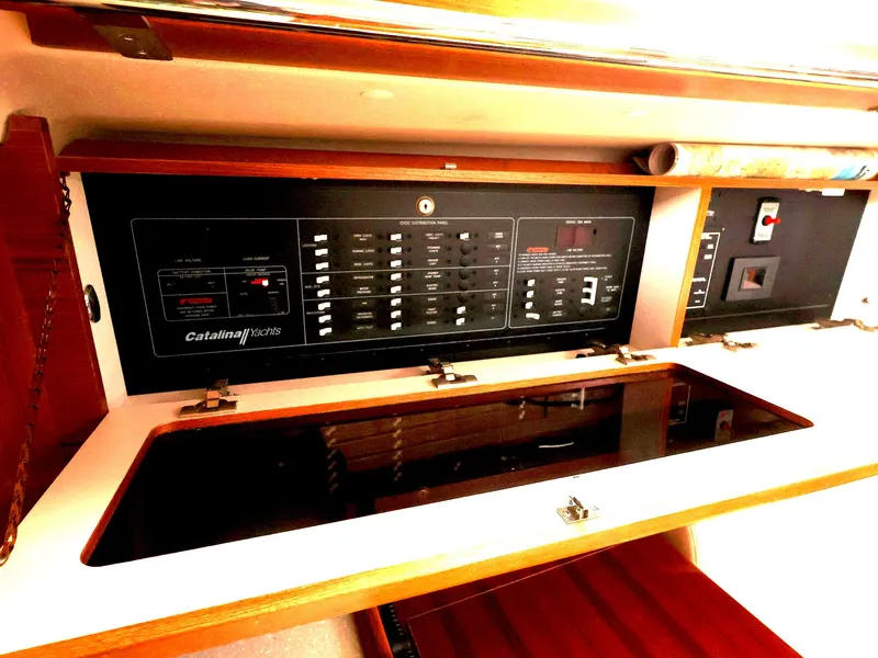 Slide: The Image of Electrical panel inside a 2021 Catalina C355 sailboat, featuring various switches and controls. - 32