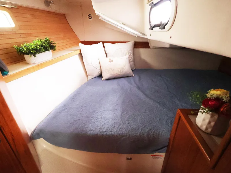 Slide: The Image of Cozy cabin interior of 2021 Catalina C355 sailboat with bed and porthole. - 34