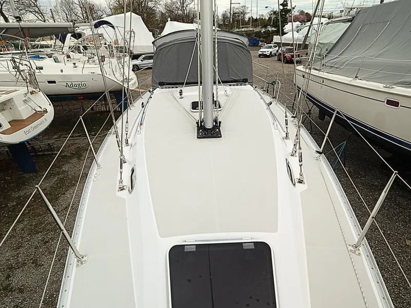 Slide: The Image of 2021 Catalina C355 sailboat deck view in marina, surrounded by other boats. - 6