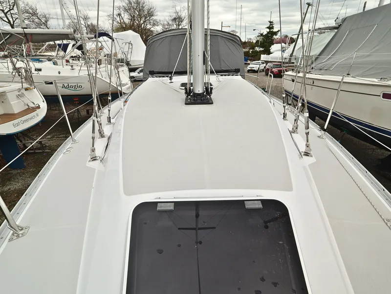 Slide: The Image of Catalina C355 sailboat deck, 2021 model, docked among other boats. - 8