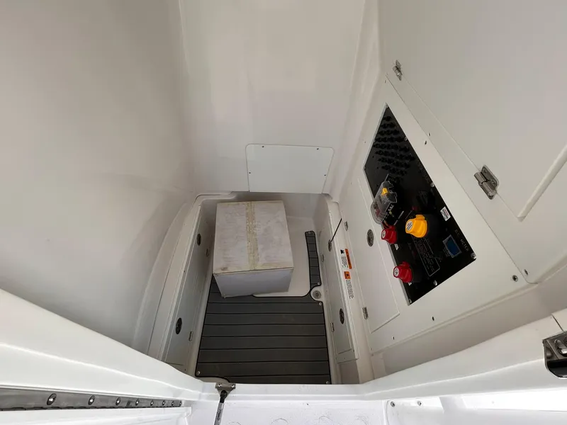 Slide: The Image of 2025 Caymas 26 HB interior compartment with control panel and storage box. - 10