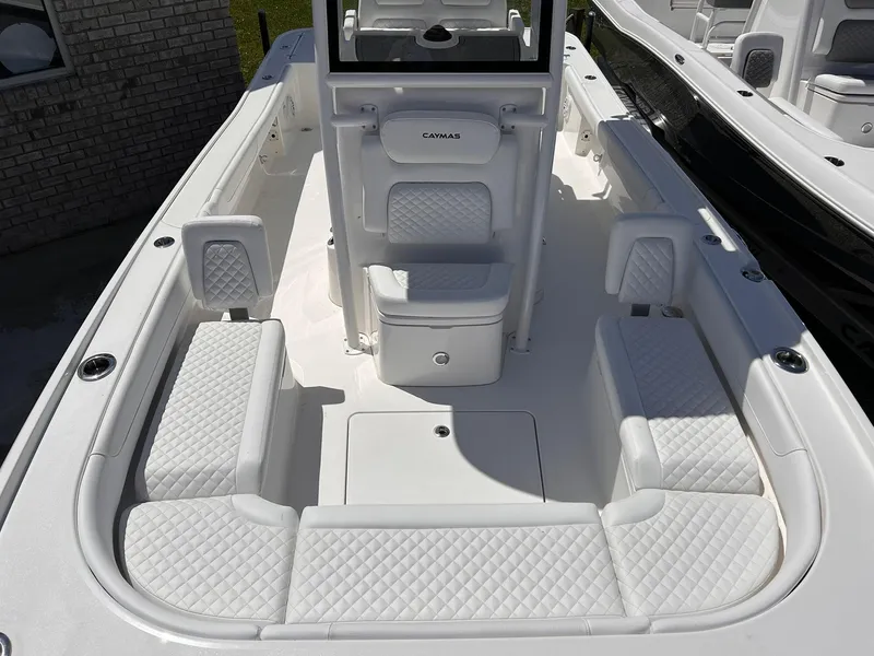 Slide: The Image of 2025 Caymas 26 HB boat interior with white cushioned seating and modern design. - 4