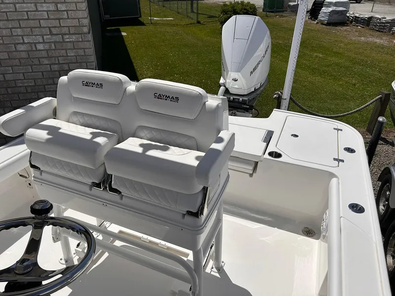 Slide: The Image of 2025 Caymas 26 HB boat with dual white seats and steering wheel. - 6