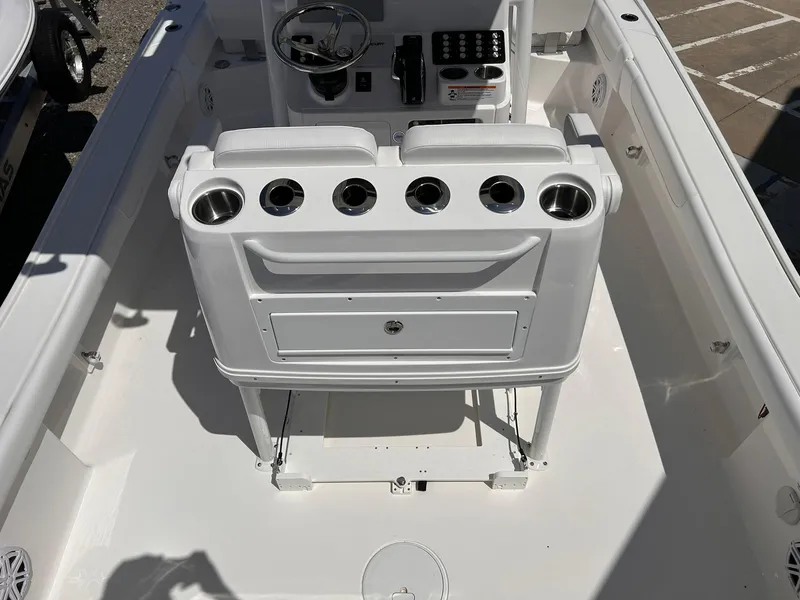 Slide: The Image of 2025 Caymas 26 HB boat interior with console and seating, featuring multiple cup holders. - 8