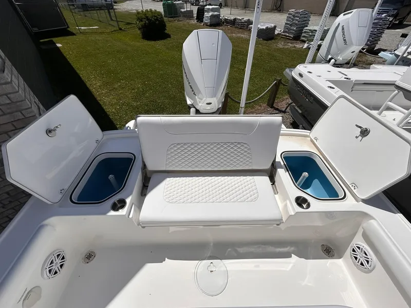 Slide: The Image of 2025 Caymas 26 HB boat interior with seating and storage compartments open. - 9
