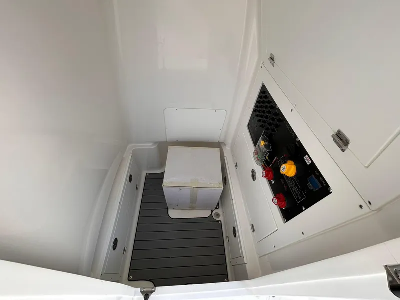 Slide: The Image of 2025 Caymas 28 HB interior compartment with control panel and storage box. - 10