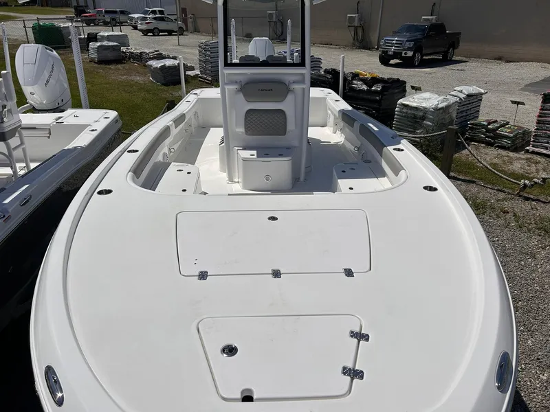 Slide: The Image of 2025 Caymas 28 HB boat, white deck, parked outdoors, showcasing spacious layout. - 3