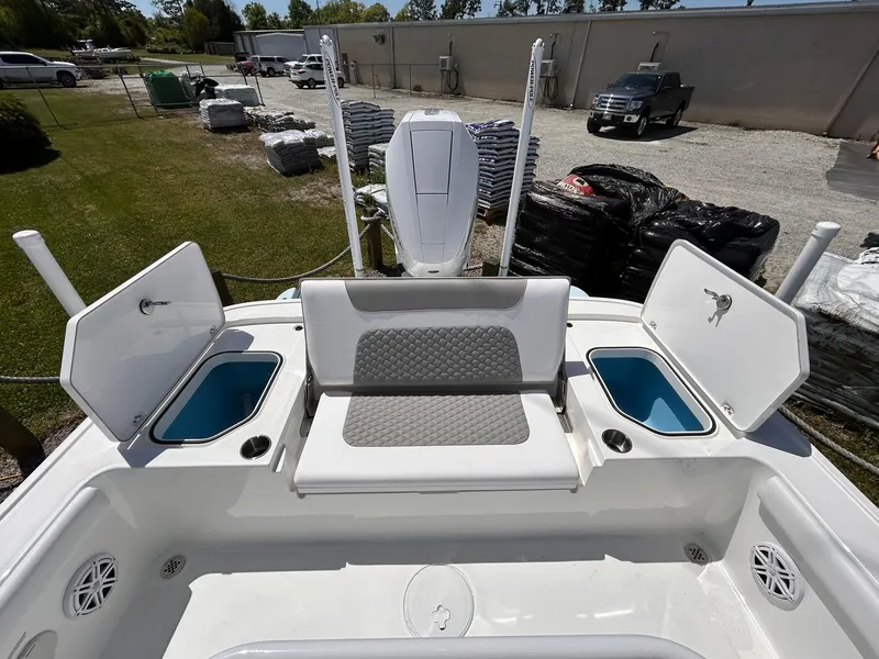 Slide: The Image of 2025 Caymas 28 HB boat with open storage compartments and seating area. - 8