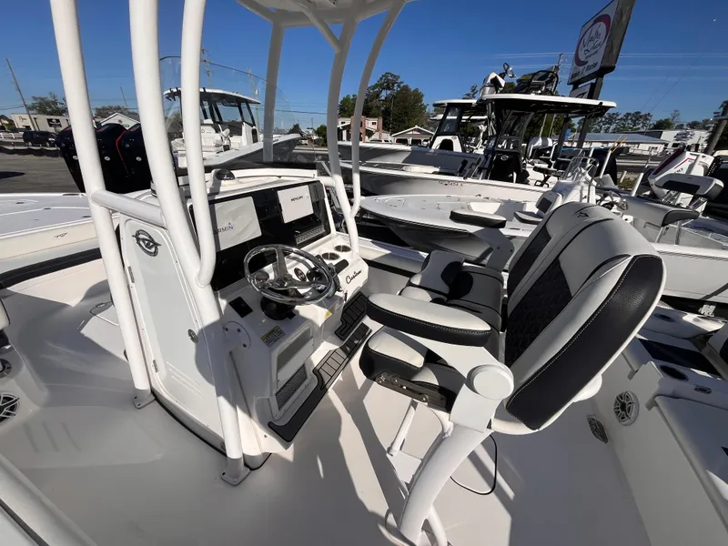 Slide: The Image of 2021 Tidewater 2500 Carolina Bay boat interior with steering console and seating. - 13