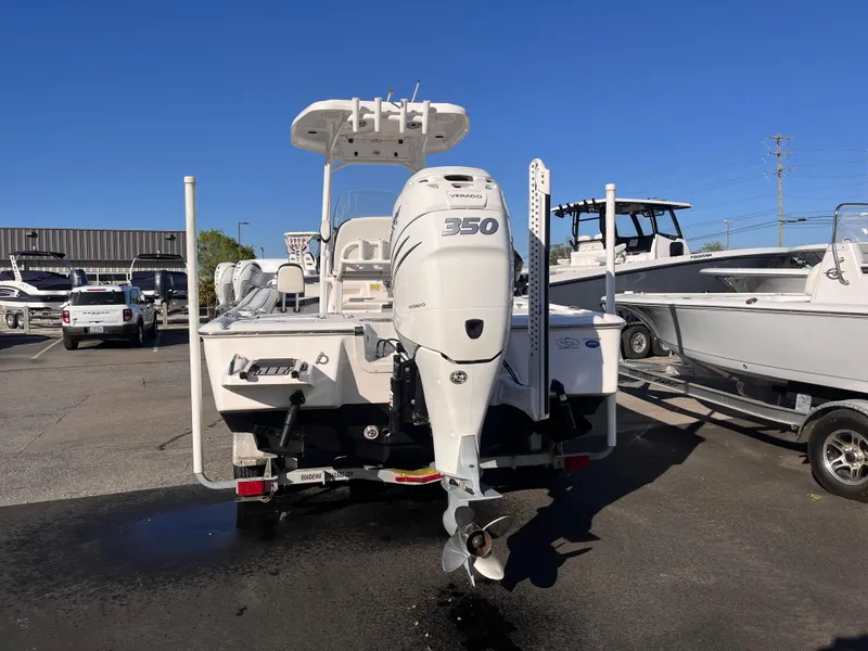 Slide: The Image of 2021 Tidewater 2500 Carolina Bay boat with powerful 350 engine, parked in a marina. - 3