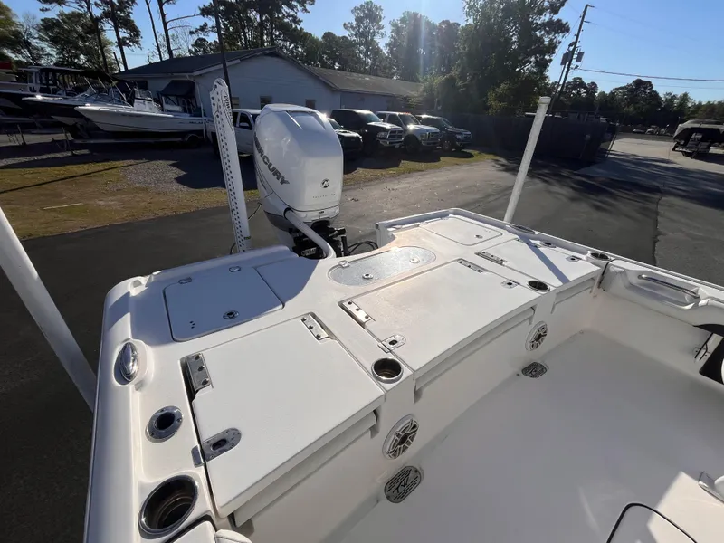 Slide: The Image of 2021 Tidewater 2500 Carolina Bay boat with outboard motor, parked outdoors. - 5