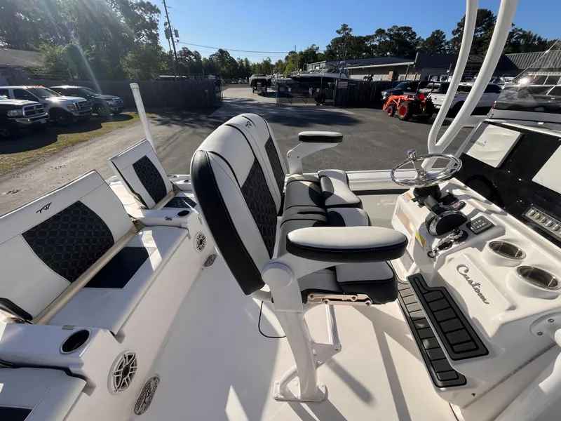 Slide: The Image of 2021 Tidewater 2500 Carolina Bay boat interior with seating and control panel. - 7