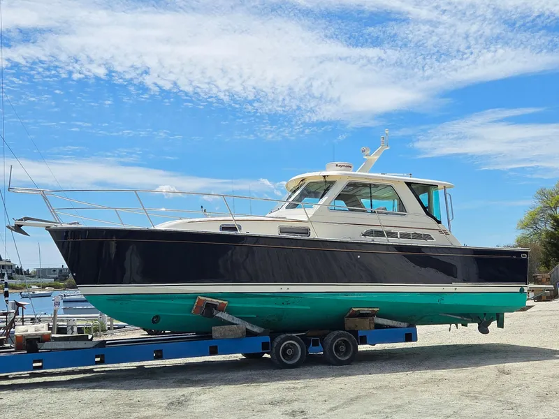 Slide: The Image of 2007 Sabre 34 Hardtop Express boat on trailer under blue sky. - 1