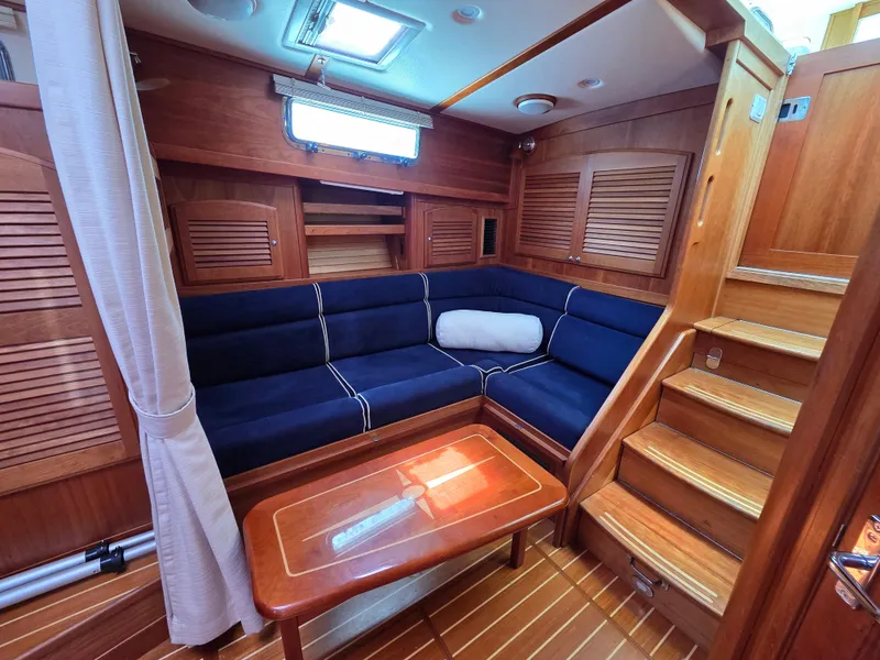 Slide: The Image of 2007 Sabre 34 Hardtop Express interior with blue seating and wooden accents. - 10