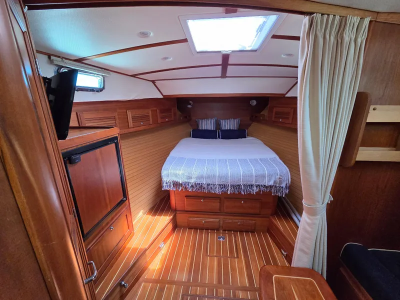 Slide: The Image of 2007 Sabre 34 Hardtop Express cabin with wood interior and cozy bed. - 11