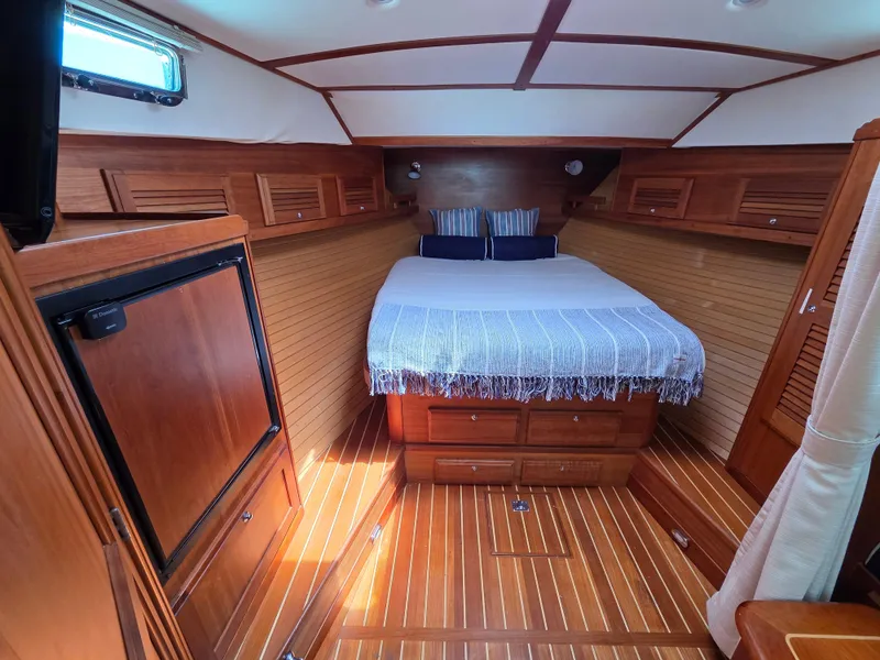 Slide: The Image of 2007 Sabre 34 Hardtop Express cabin with wood interior and cozy bed. - 12