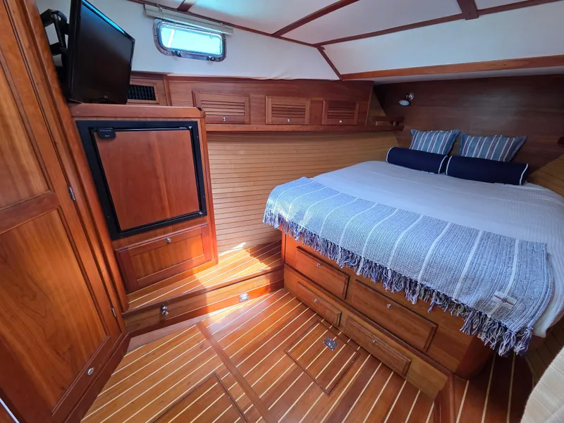 Slide: The Image of 2007 Sabre 34 Hardtop Express cabin with wood interior, bed, and storage. - 13