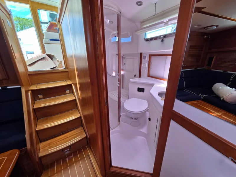 Slide: The Image of 2007 Sabre 34 Hardtop Express interior with wooden stairs, bathroom, and seating area. - 14