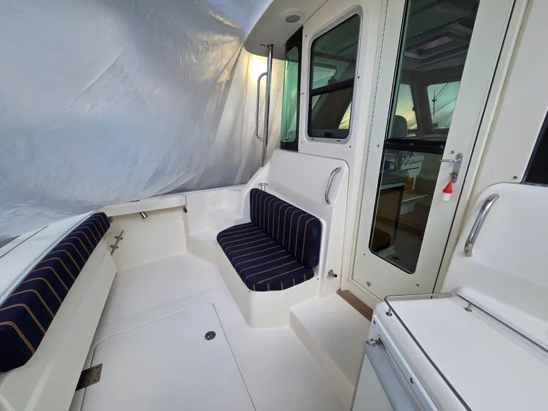 Slide: The Image of 2007 Sabre 34 Hardtop Express interior with striped seating and enclosed cabin. - 16