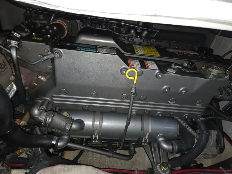 Slide: The Image of Engine compartment of a 2007 Sabre 34 Hardtop Express boat, showcasing mechanical components. - 19