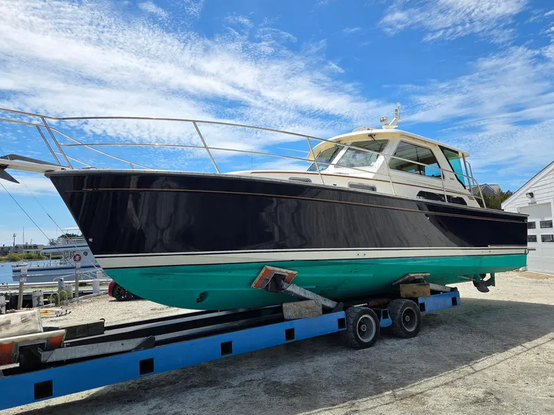 Slide: The Image of 2007 Sabre 34 Hardtop Express boat on trailer under blue sky. - 2