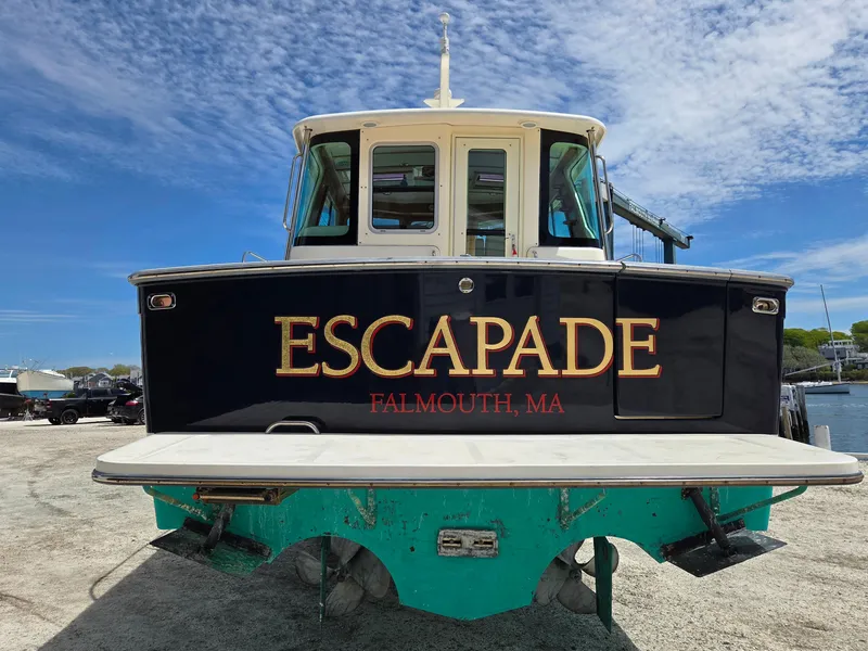 Slide: The Image of 2007 Sabre 34 Hardtop Express boat named "Escapade" in Falmouth, MA, docked under blue sky. - 3