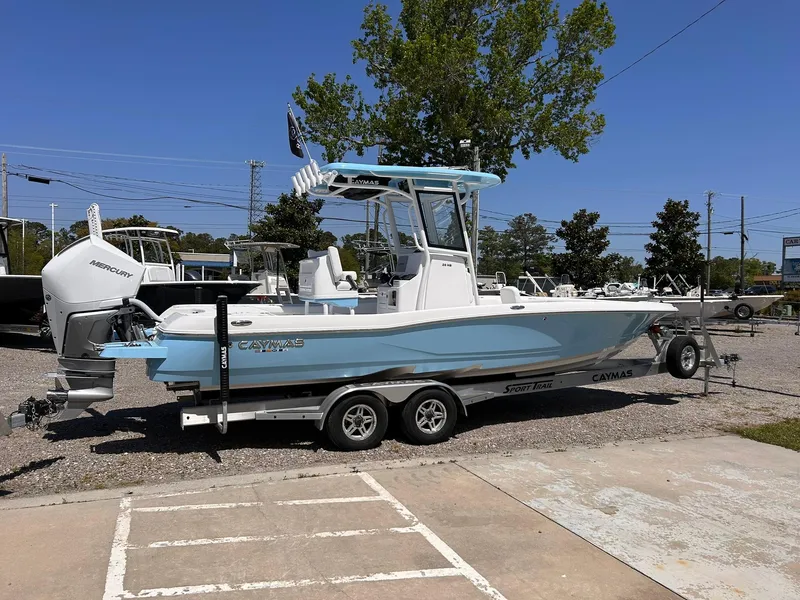 Slide: The Image of 2025 Caymas 26 HB boat on trailer, light blue hull, parked outdoors. - 3