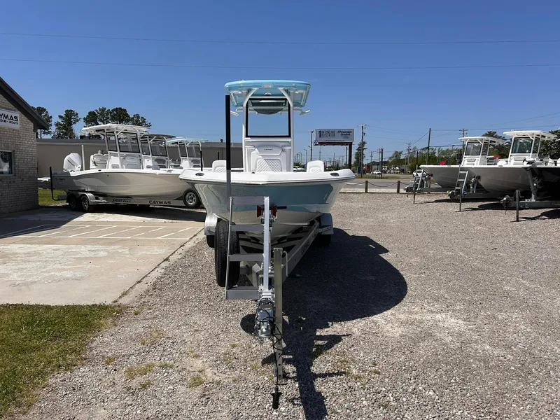 Slide: The Image of 2025 Caymas 26 HB boat on trailer in outdoor dealership lot. - 4