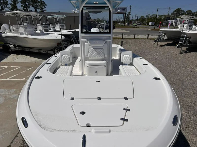 Slide: The Image of 2025 Caymas 26 HB boat with spacious deck and seating, displayed outdoors. - 5