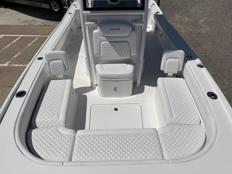 Slide: The Image of 2025 Caymas 26 HB boat interior with white quilted seating and spacious deck layout. - 6