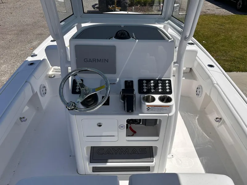Slide: The Image of 2025 Caymas 26 HB boat console with Garmin system and steering wheel. - 8