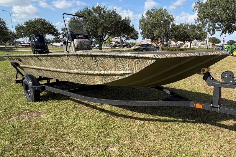 The Image of A 2025 Tracker Grizzly 2072 CC on a trailer, parked on grass, with trees in the background. - 0