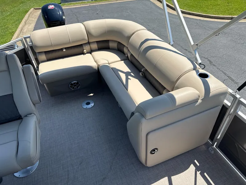 Slide: The Image of 2025 Sun Tracker Party Barge 20 DLX with beige seating and spacious deck layout. - 7