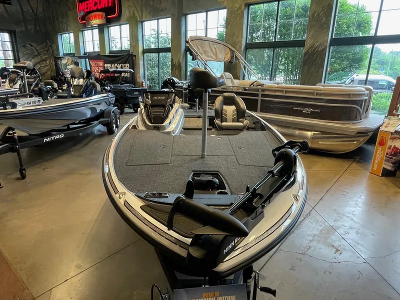 Slide: The Image of 2024 Nitro Z18 boat displayed in showroom with other boats. - 1