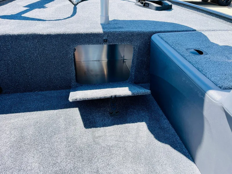 Slide: The Image of 2025 Tracker Bass Tracker Classic XL boat interior with carpeted flooring and storage compartment. - 10