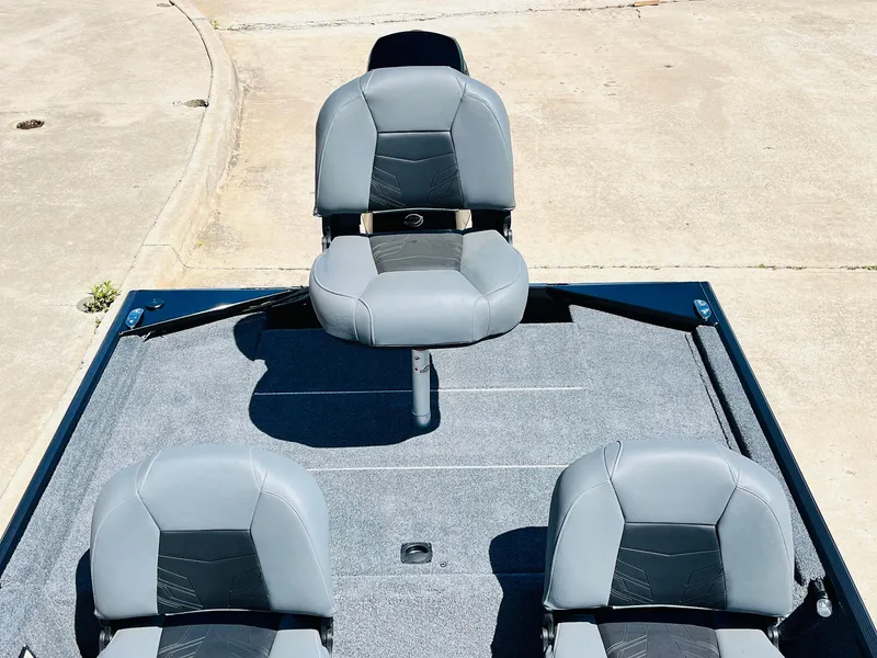 Slide: The Image of 2025 Tracker Bass Tracker Classic XL boat seats on deck, featuring gray upholstery. - 19