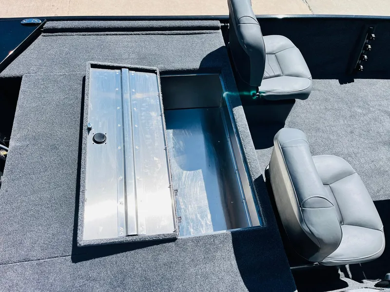 Slide: The Image of 2025 Tracker Bass Tracker Classic XL boat interior with storage compartment and seating. - 24