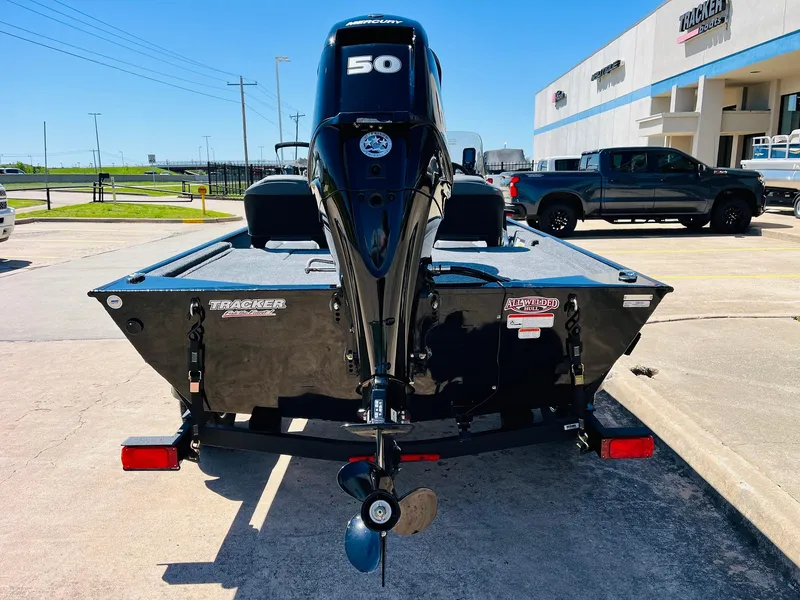 Slide: The Image of 2025 Tracker Bass Tracker Classic XL boat with 50 HP engine, parked outdoors. - 3