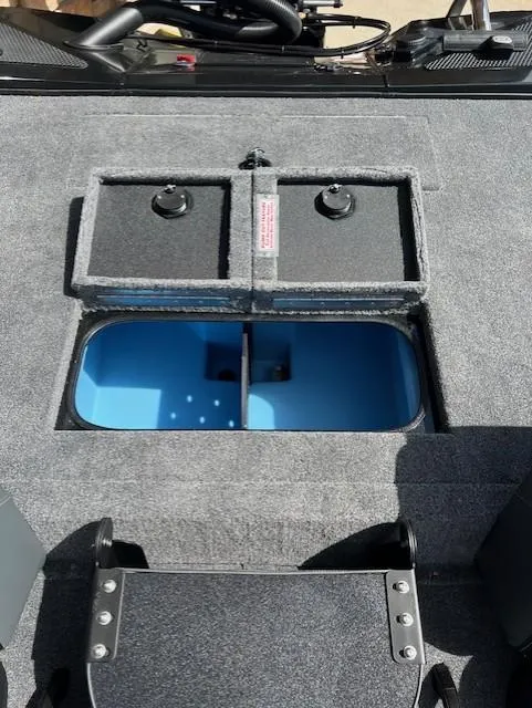 Slide: The Image of 2025 Tracker Savage 215 boat storage compartments with open lids and blue interior. - 10