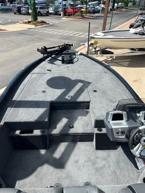 Slide: The Image of 2025 Tracker Savage 215 boat with a powerful black outboard motor. - 3