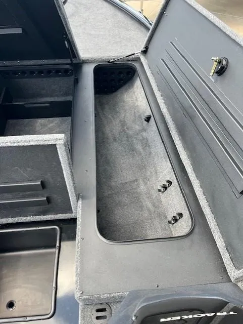 Slide: The Image of 2025 Tracker Savage 215 boat storage compartment with open lid, showcasing interior space. - 5