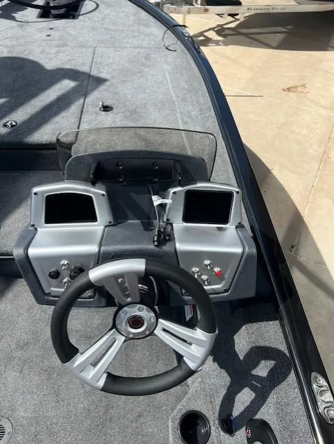 Slide: The Image of Steering console of 2025 Tracker Savage 215 boat with dual displays and modern controls. - 8