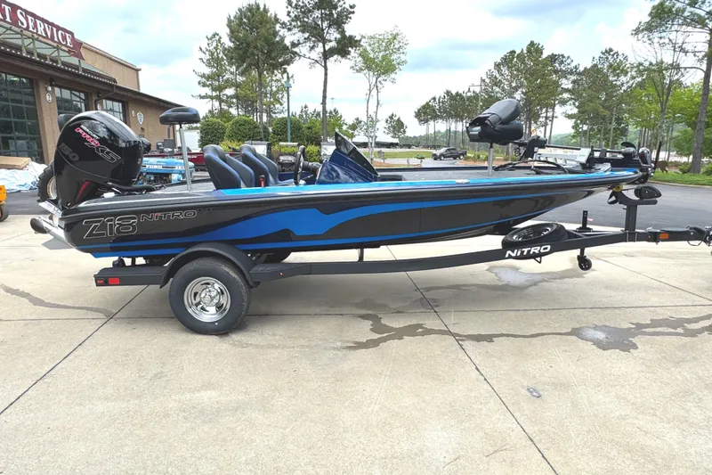 Slide: The Image of 2025 Nitro Z18 Pro boat with blue accents parked outdoors. - 1