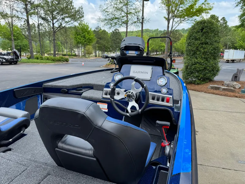 Slide: The Image of 2025 Nitro Z18 Pro boat interior with Garmin navigation system, steering wheel, and seating. - 2