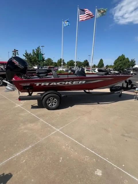 The Image of 2025 Tracker Pro Team 195 Tournament Edition boat on trailer, flags in background. - 0