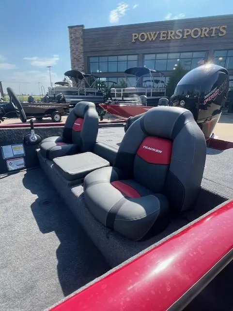 Slide: The Image of 2025 Tracker Pro Team 195 Tournament Edition boat with red and gray seating at Powersports dealership. - 4
