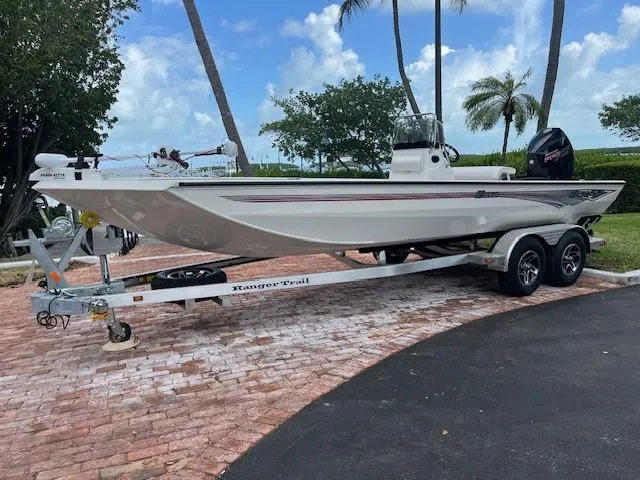 The Image of 2025 Ranger RB210 boat on trailer, parked outdoors with trees in background. - 0