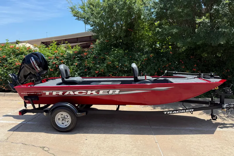 The Image of 2025 Tracker Panfish 17 boat on trailer, red exterior, parked outdoors. - 0