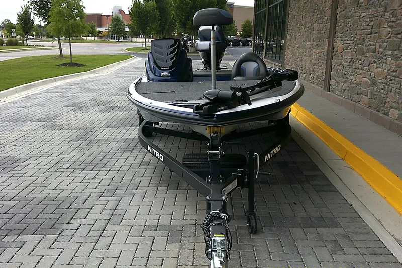 Slide: The Image of 2025 Nitro Z17 boat on a trailer, parked on a paved area near a building. - 1
