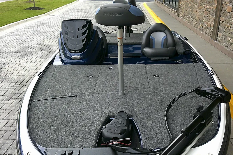 Slide: The Image of 2025 Nitro Z17 boat interior with seating and equipment on a paved surface. - 3